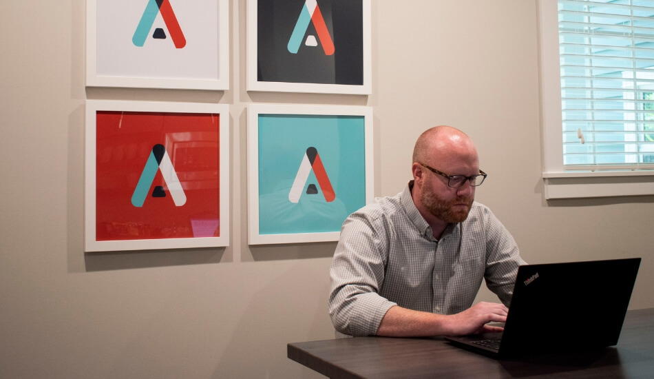 man looking at a laptop